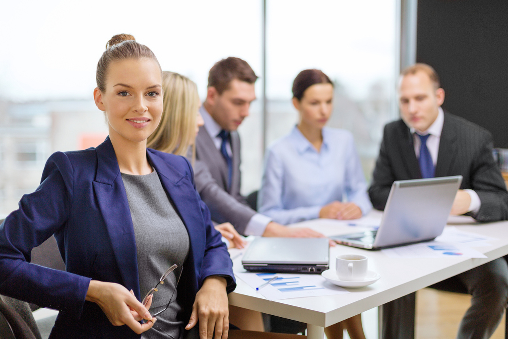 A group of male and female professionals collaborates, highlighting women’s contributions to engineering and innovation.